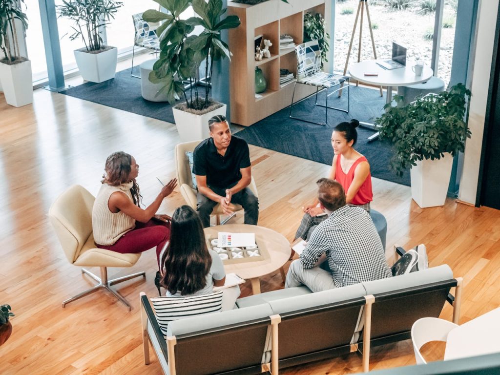 pexels-photo-7688173 A diverse group of professionals engage in a collaborative team meeting in a stylish office environment.